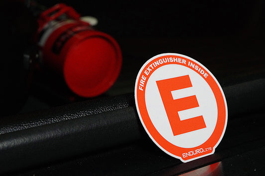 Fire extinguisher safety label with 'E' on a dark background Endurolite